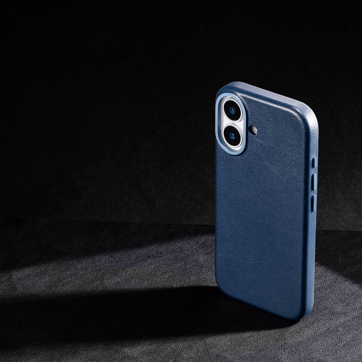 iphone 17 leather case in steel blue - raised camera ring and colour matched metal buttons detailing