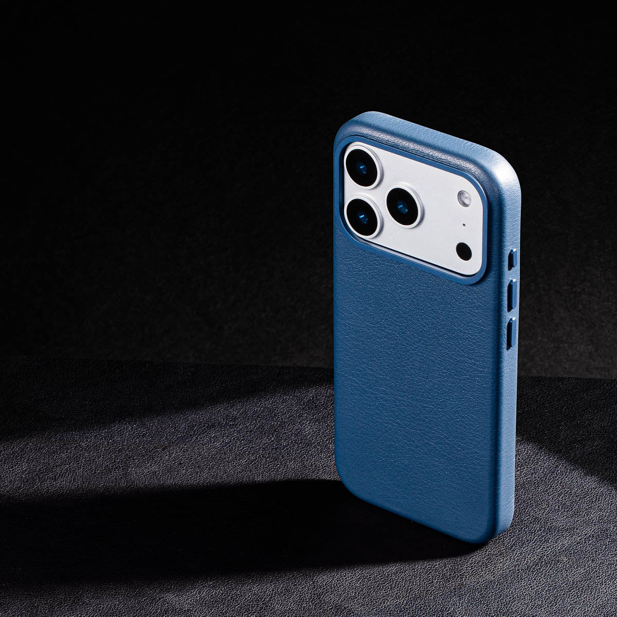 iphone 17 pro leather case in steel blue - raised camera ring and colour matched metal buttons detailing