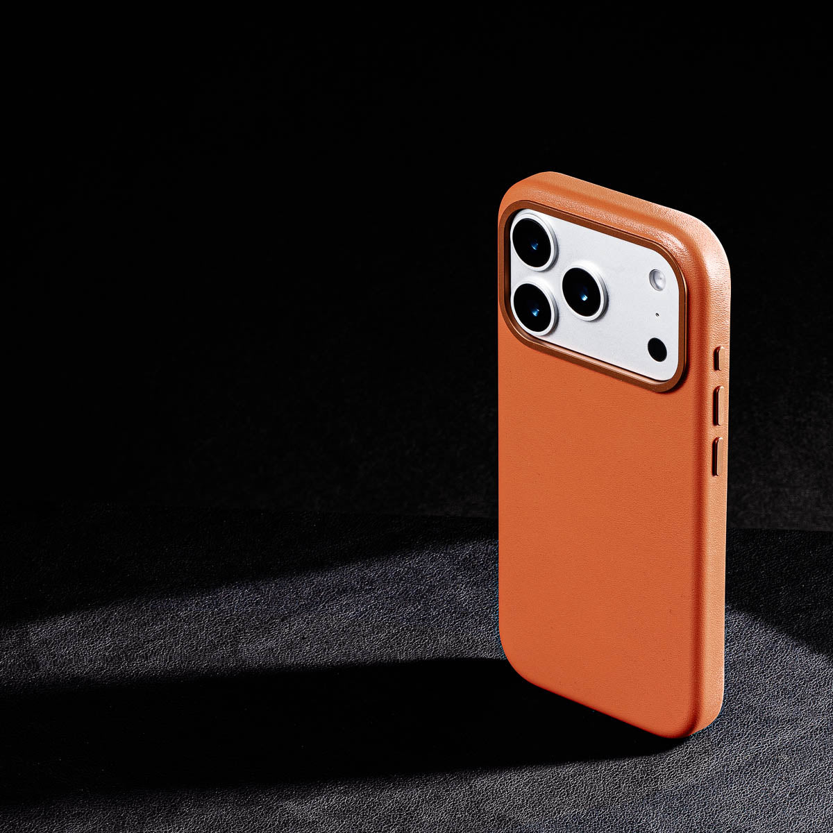 iphone 17 pro max leather case in cognac brown - raised camera ring and colour matched metal buttons detailing