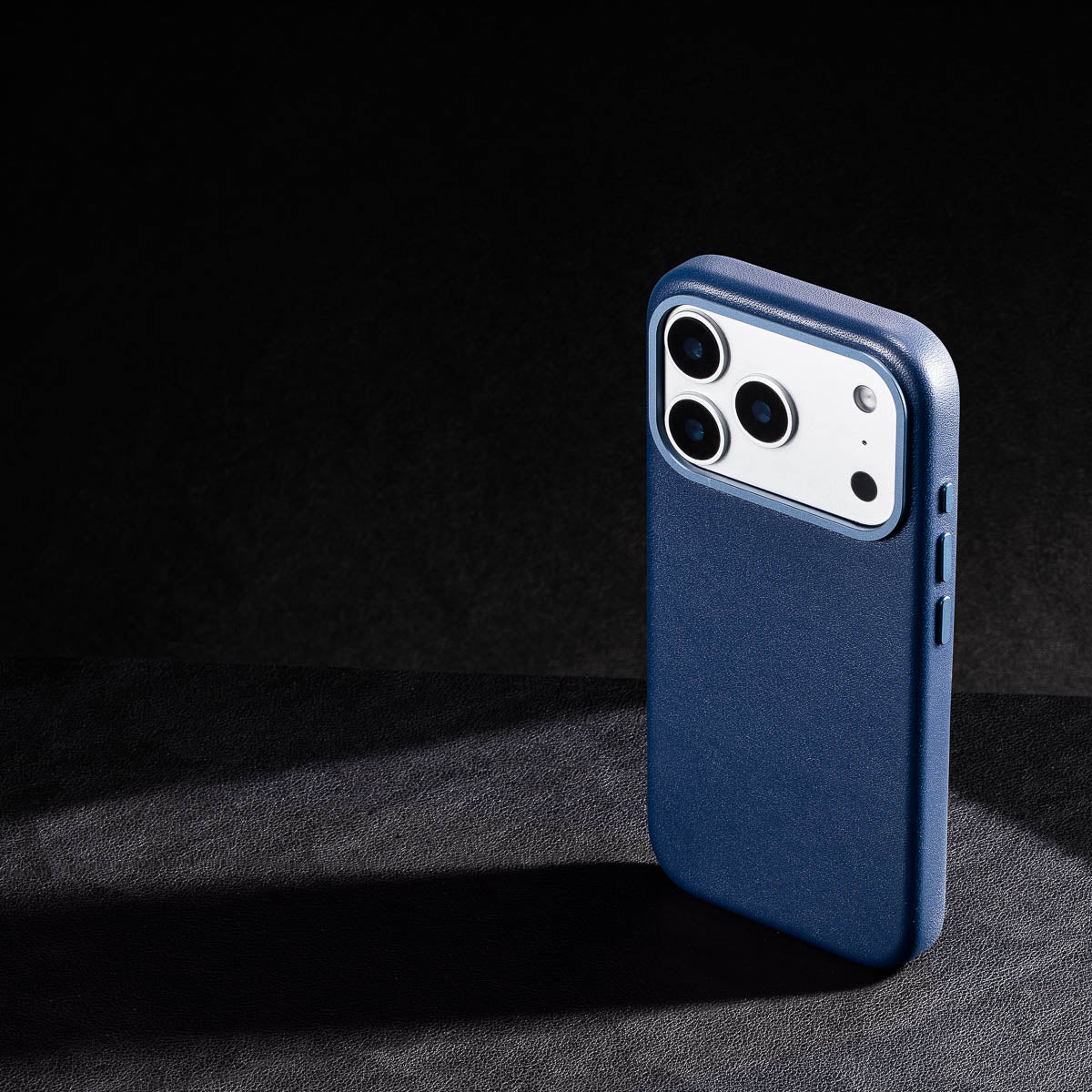 iphone 17 pro max leather case in steel blue - raised camera ring and colour matched metal buttons detailing
