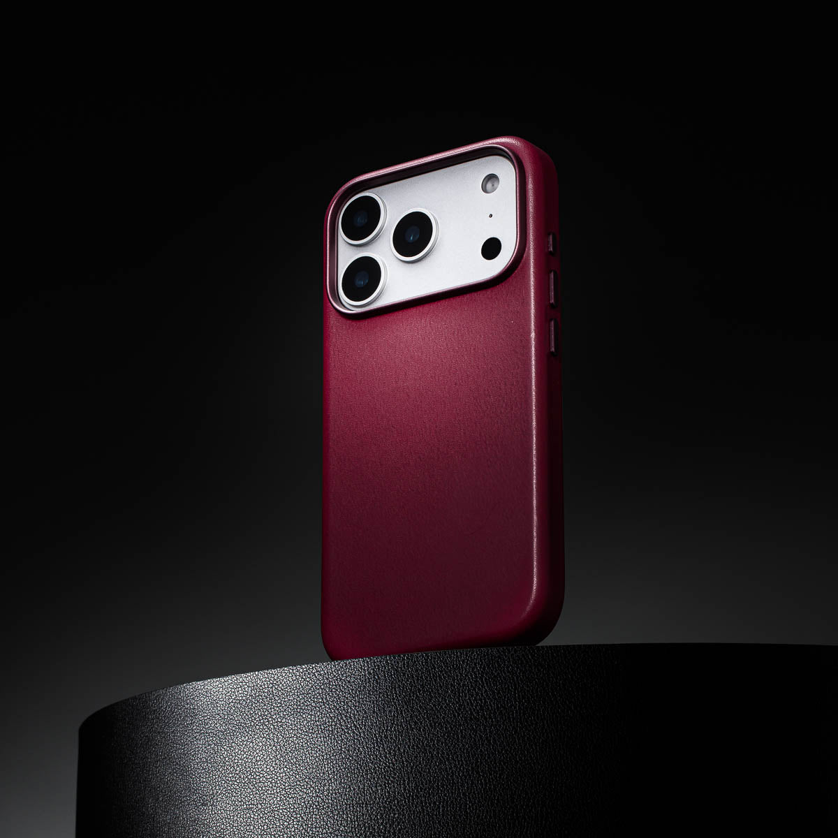 cherry leather iphone 18 pro case standing upright showing slim profile and curved edges