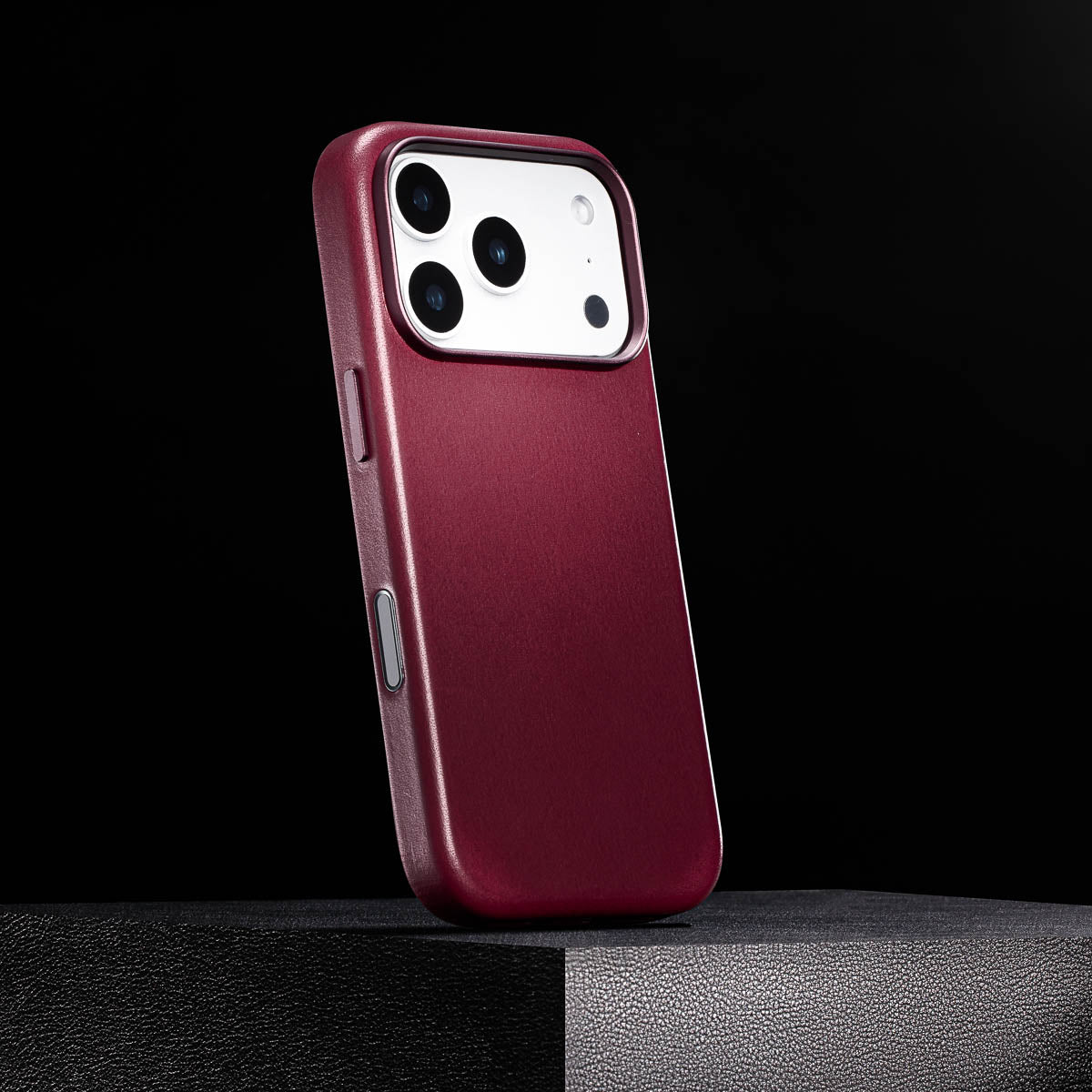 side view of cherry iphone 18 pro leather case with colour matched metal buttons and camera control button