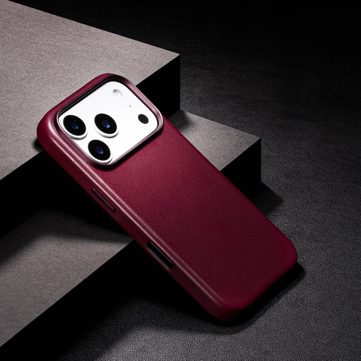 close up of cherry iphone 18 pro leather case camera frame and full grain vachetta texture
