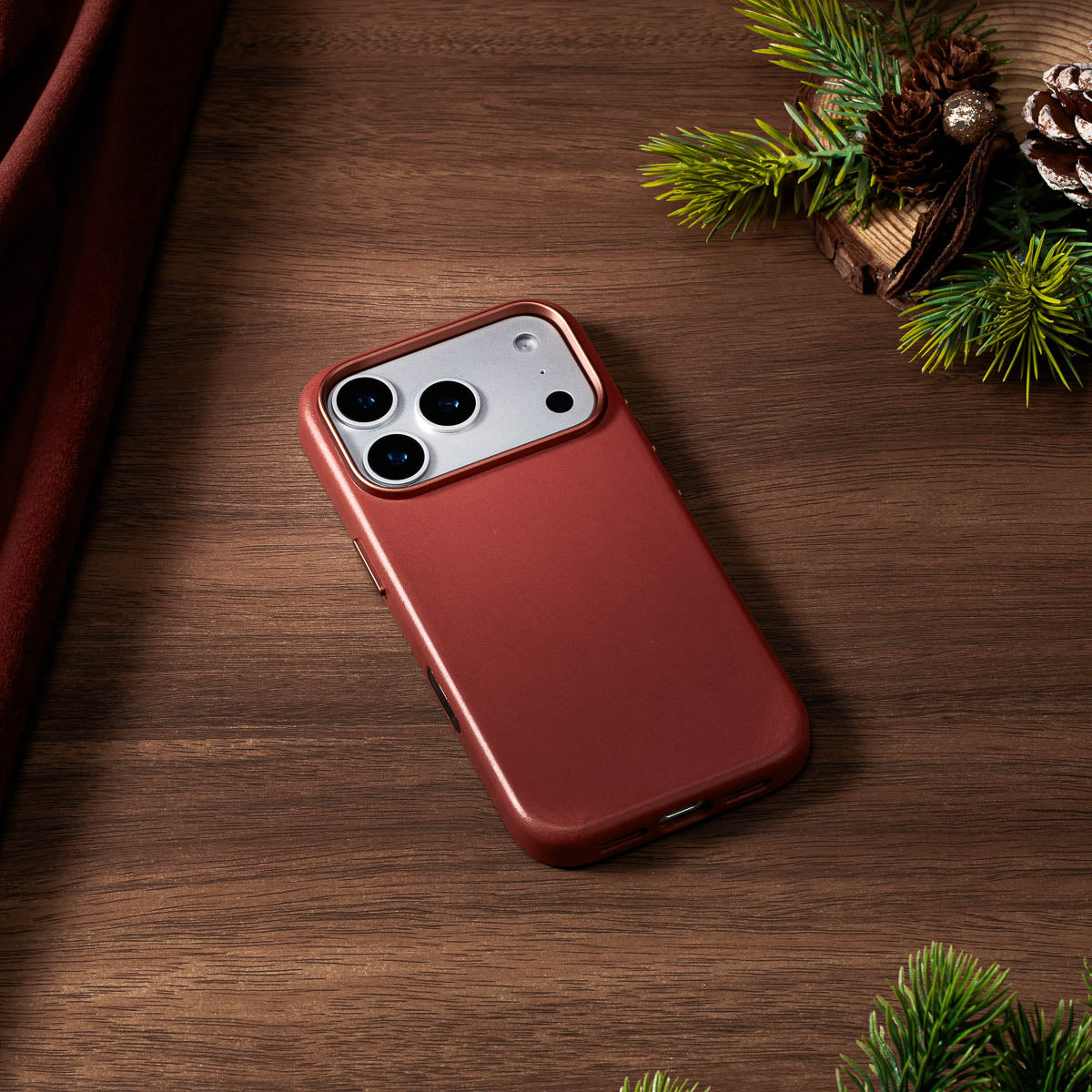umber vachetta leather case for iphone 18 pro lying flat on wooden desk