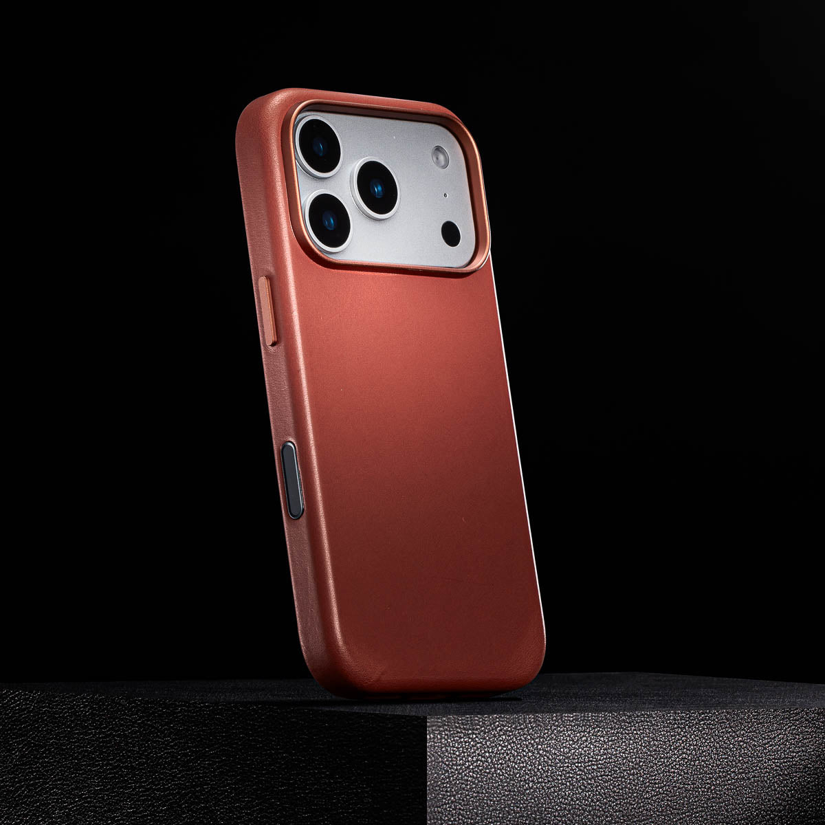 side view of umber iphone 18 pro leather case with colour matched metal buttons and camera control button