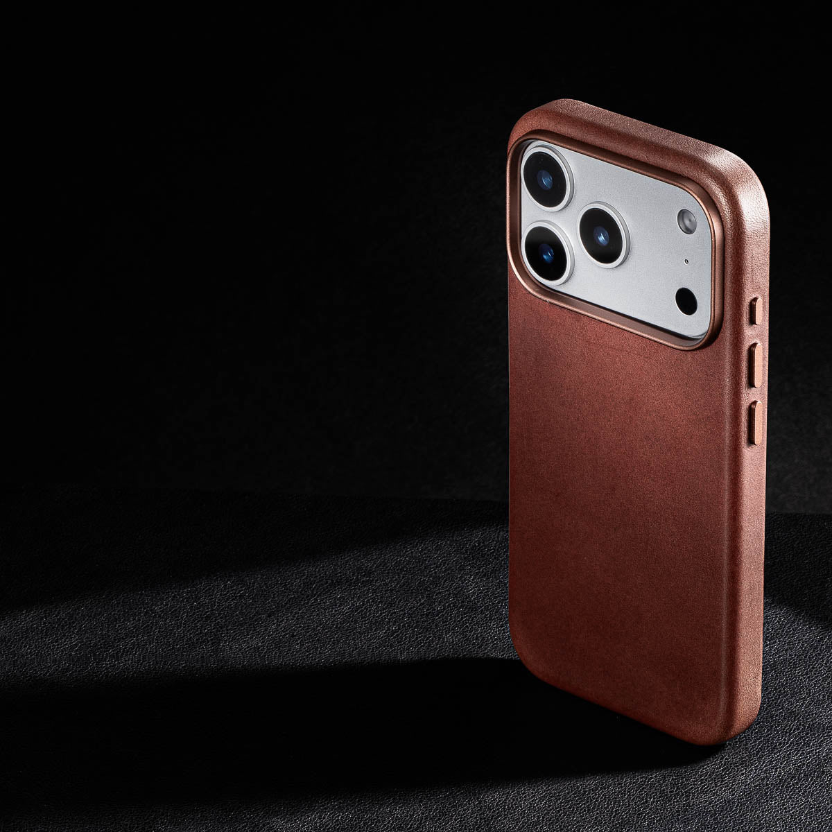 rear three-quarter view of dark brown vachetta leather case for iphone 18 pro max showing raised camera ring