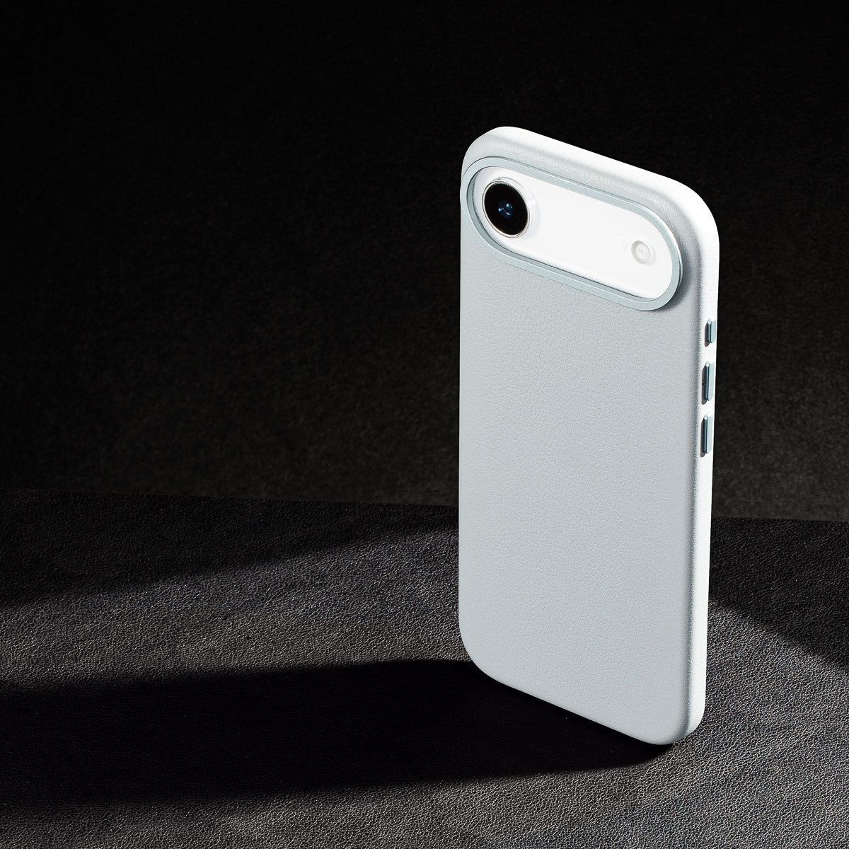 iphone air leather case in pale blue - raised camera ring and colour matched metal buttons detailing